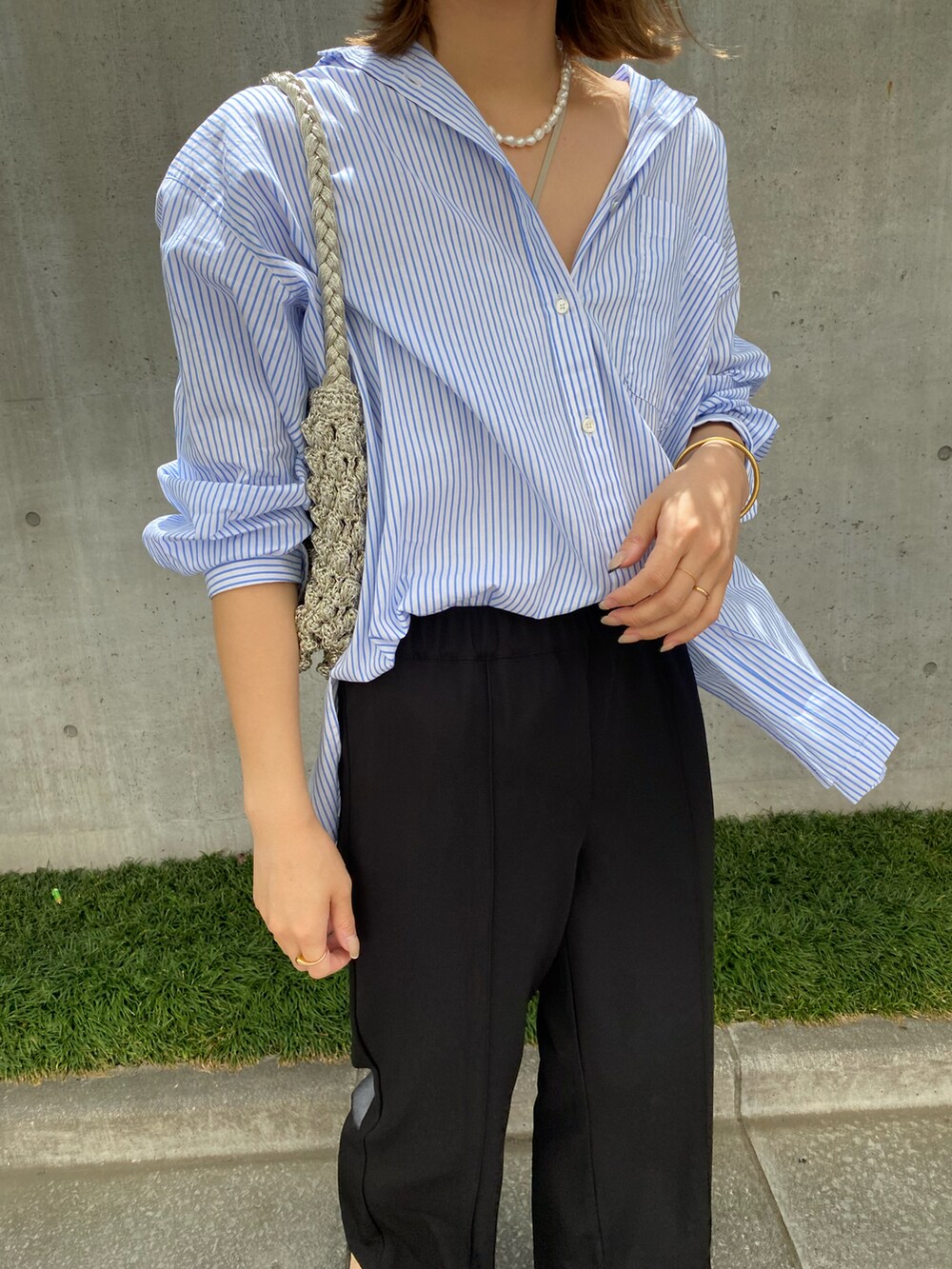 ブラック系のその他パンツ、ブルー系のシャツ/ブラウスを着用したレディースの春コーディネートの2枚目の写真