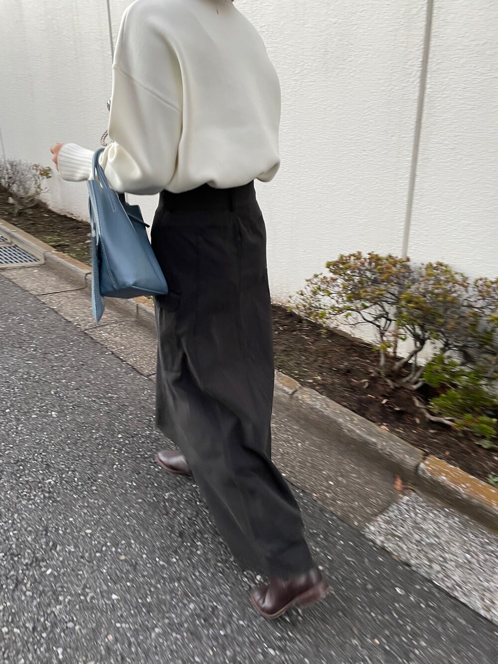 ブラウン系のブーツ、グリーン系のスカートを着用したレディースの冬コーディネートの2枚目の写真