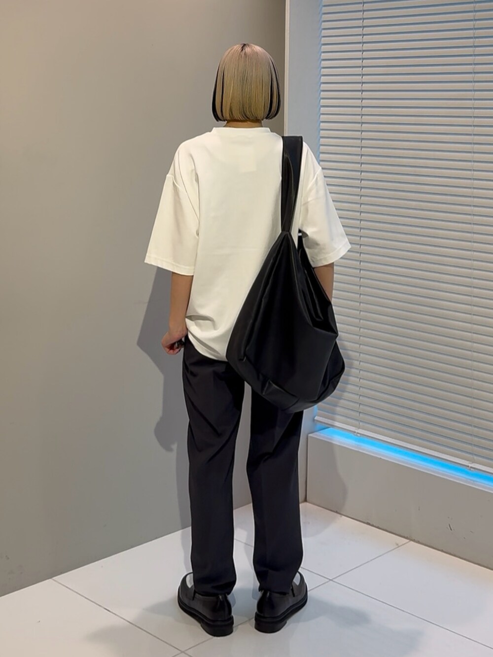 ホワイト系のTシャツ/カットソー、ブラック系のショルダーバッグ、ブラック系のその他シューズを着用したレディースの春コーディネートの3枚目の写真