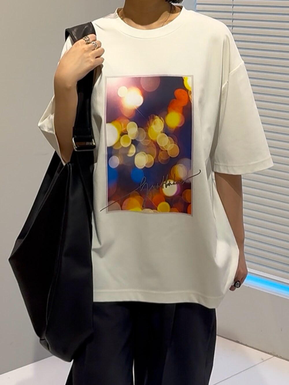 ホワイト系のTシャツ/カットソー、ブラック系のショルダーバッグ、ブラック系のその他シューズを着用したレディースの春コーディネートの4枚目の写真