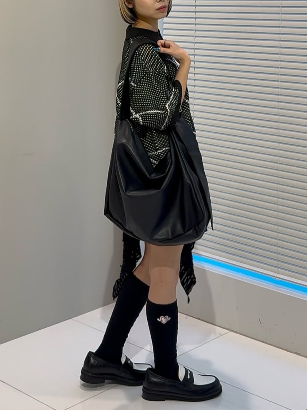 ブラック系のニット/セーター、ブラック系のショルダーバッグ、ブラック系のその他シューズを着用したレディースの春コーディネートの3枚目の写真