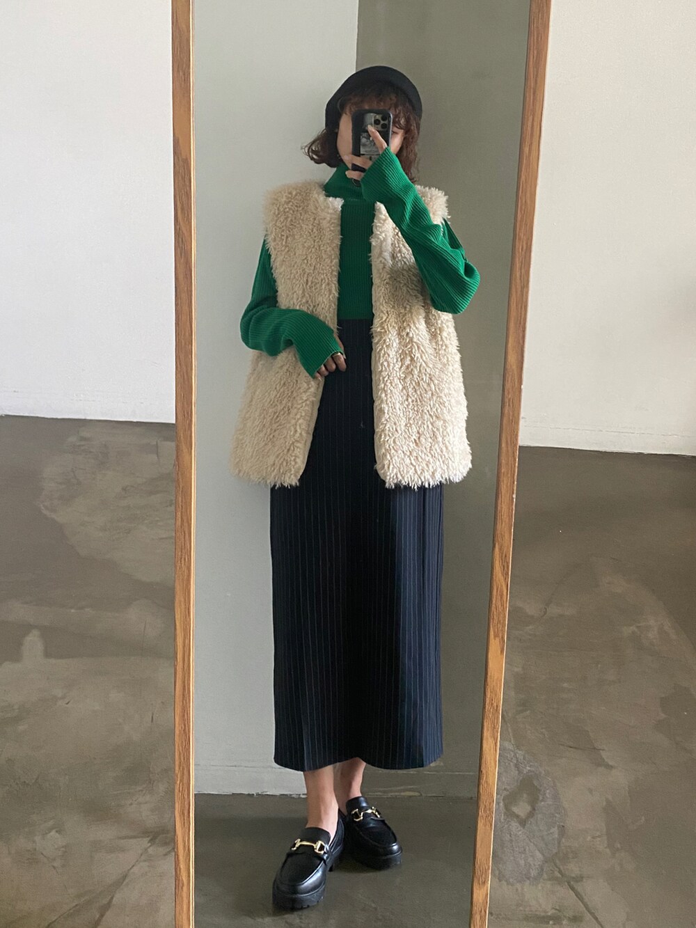 ホワイト系のスラックス、グレー系のベスト、ブルー系のニット/セーターを着用したレディースの秋コーディネートの4枚目の写真