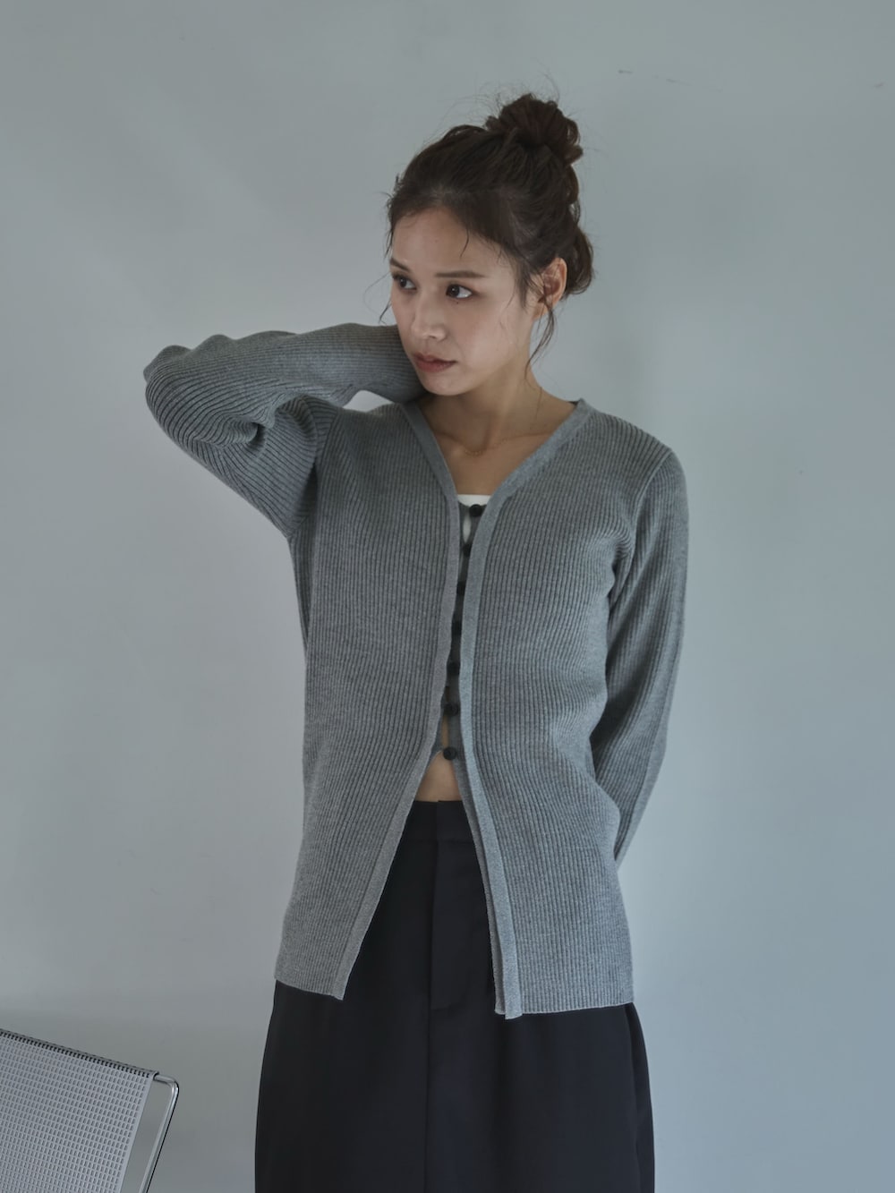 グレー系のスカート、ブラック系のサンダル、グレー系のカーディガン/ボレロを着用したレディースの秋コーディネートの2枚目の写真