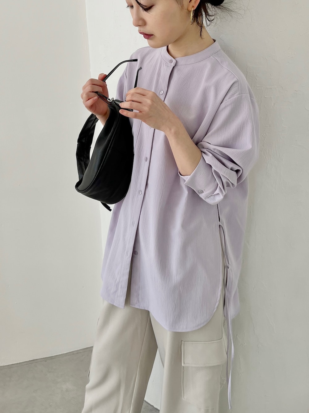 パープル系のシャツ/ブラウス、ホワイト系のカーゴパンツ、ブラック系のパンプスを着用したレディースの冬コーディネートの2枚目の写真