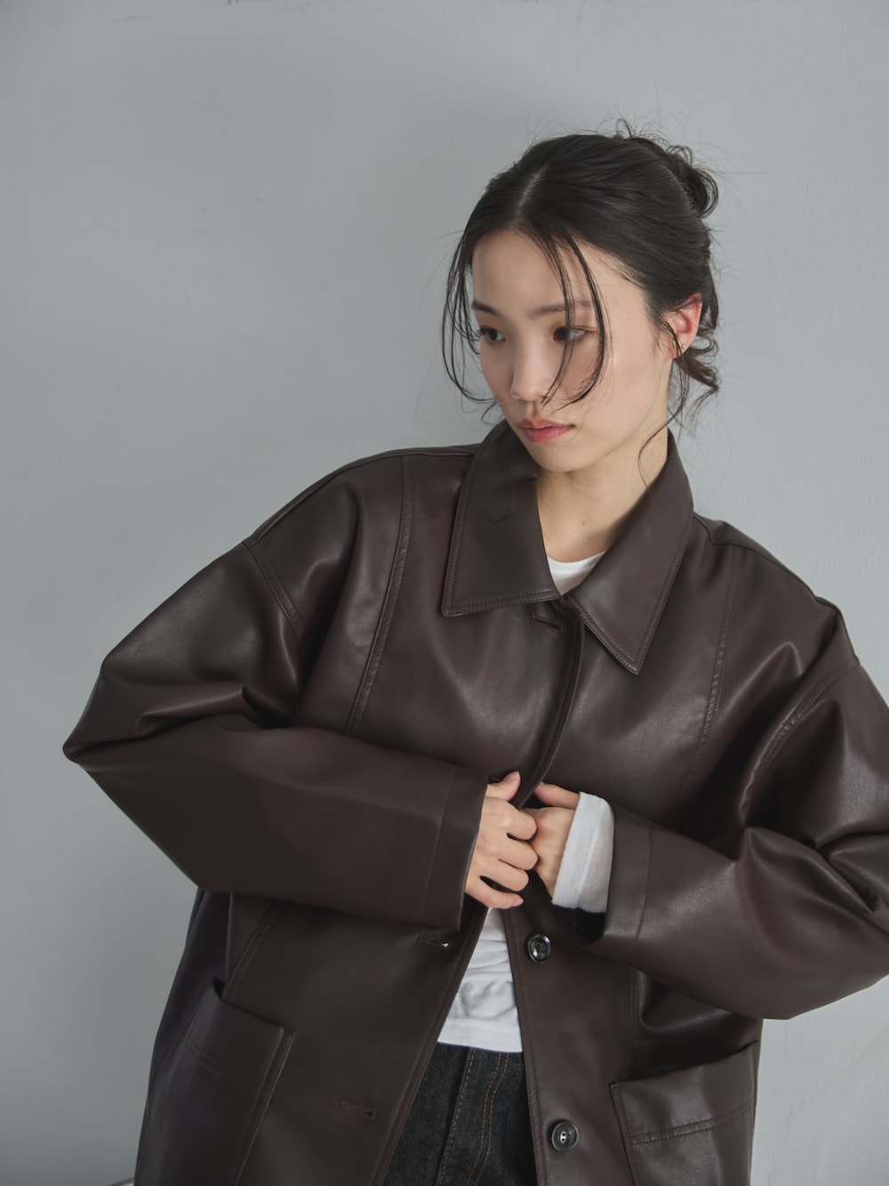 ブラウン系のカバーオール、ホワイト系のTシャツ/カットソー、ブラック系のデニムパンツを着用したレディースの冬コーディネートの7枚目の写真