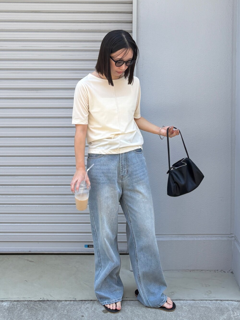 ホワイト系のTシャツ/カットソー、ブラック系のショルダーバッグ、ブルー系のデニムパンツを着用したレディースの夏コーディネートの4枚目の写真