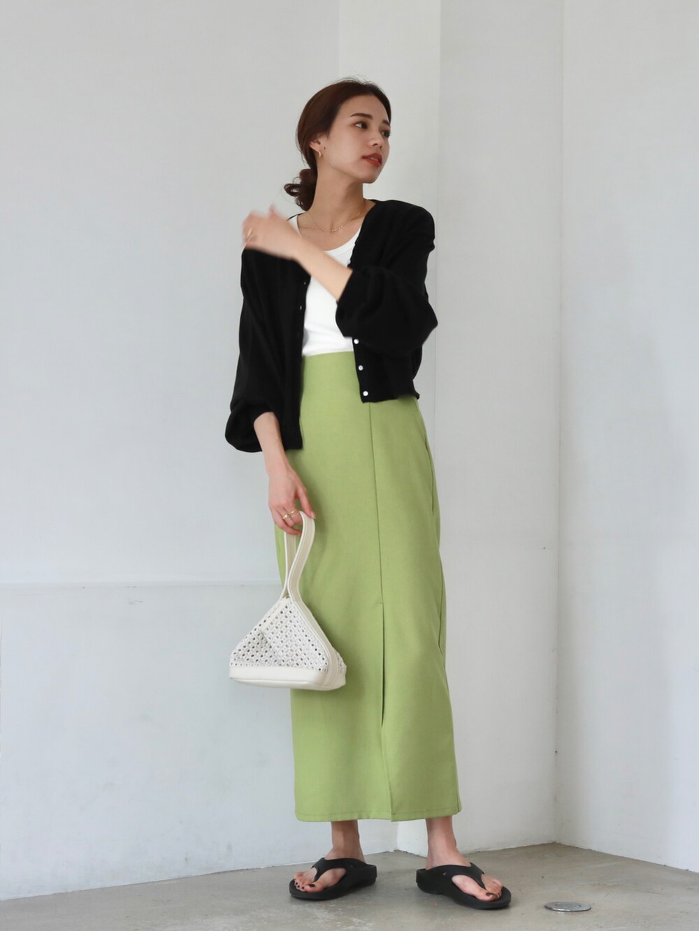 ブラック系のサンダル、ホワイト系のトートバッグ、グリーン系のスカートを着用したレディースの夏コーディネートの3枚目の写真
