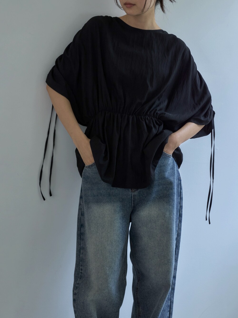 ブラック系のシャツ/ブラウス、ブルー系のデニムパンツ、ベージュ系のスニーカーを着用したレディースの夏コーディネートの4枚目の写真