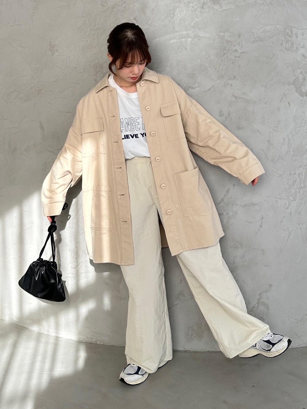 ホワイト系のその他パンツ、ブラック系のショルダーバッグ、ホワイト系のミリタリージャケットを着用したレディースの冬コーディネートの2枚目の写真