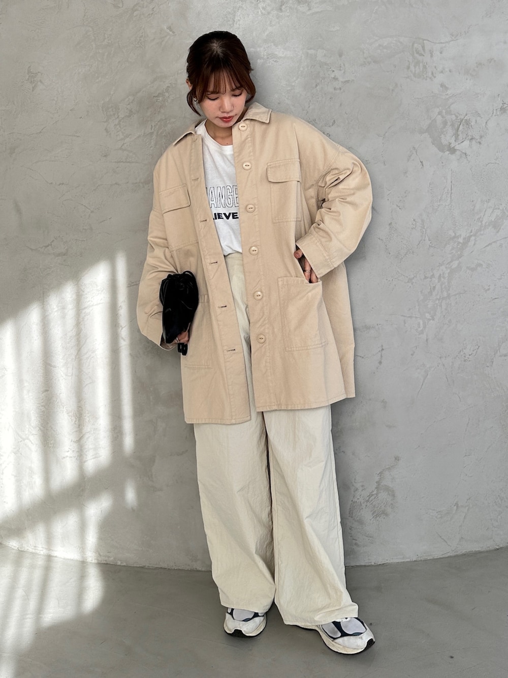 ホワイト系のその他パンツ、ブラック系のショルダーバッグ、ホワイト系のミリタリージャケットを着用したレディースの冬コーディネートの3枚目の写真