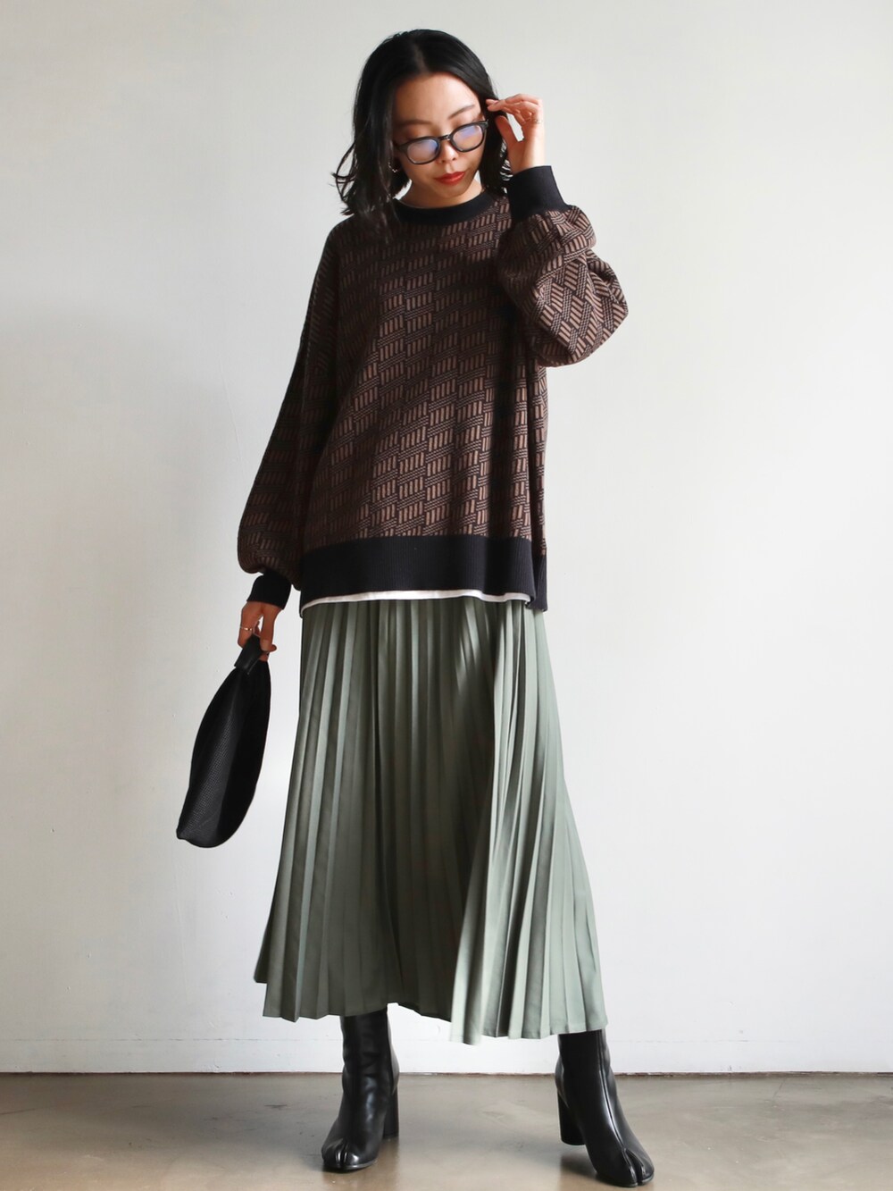 ホワイト系のトートバッグ、ブルー系のニット/セーター、ホワイト系のTシャツ/カットソーを着用したレディースの秋コーディネートの4枚目の写真