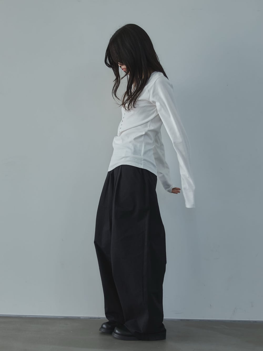 ホワイト系のTシャツ/カットソー、ブラック系のその他パンツ、ブラック系のその他シューズを着用したレディースの春コーディネートの3枚目の写真