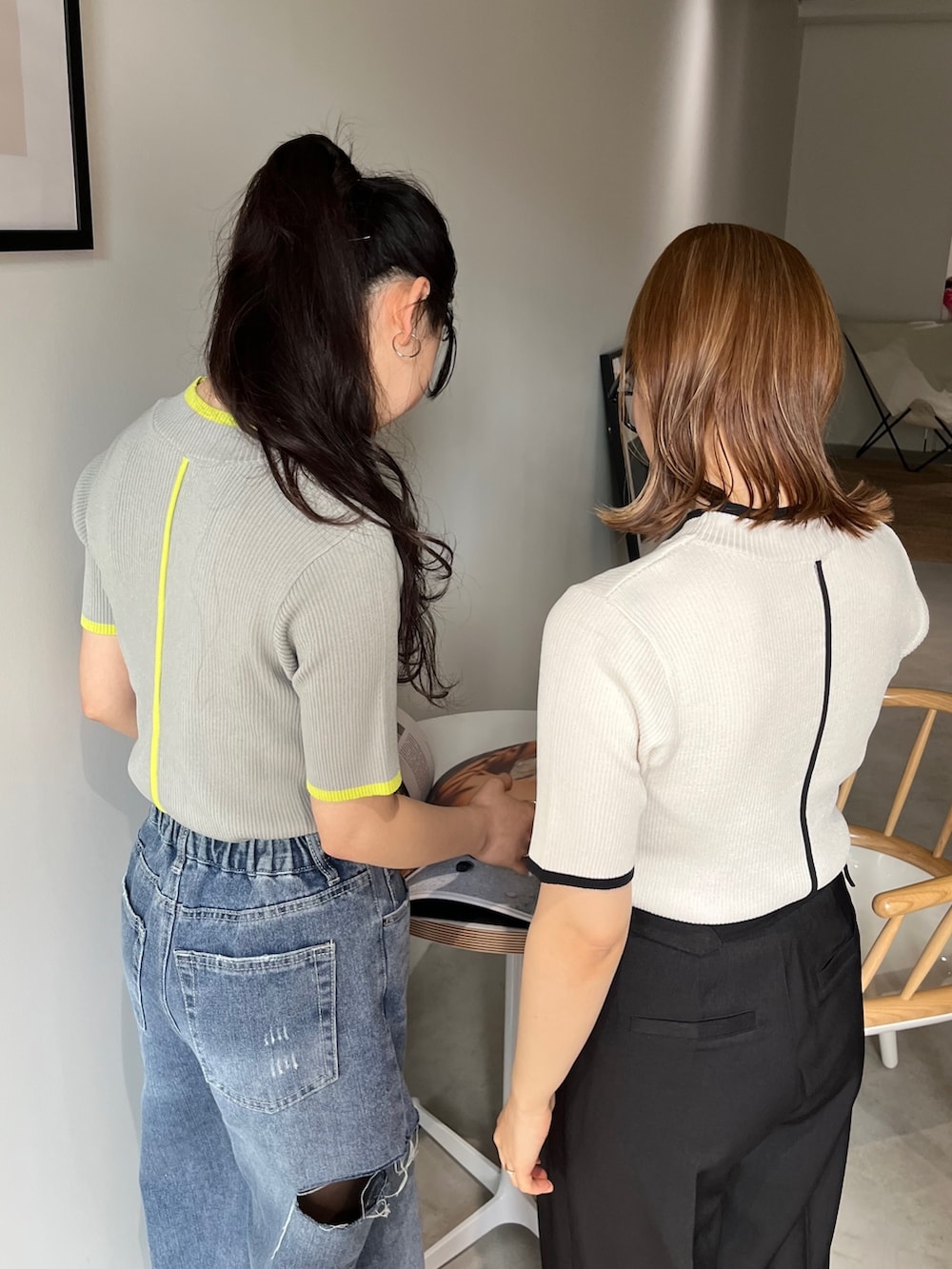 グレー系のスラックス、ブラック系のサンダル、グレー系のニット/セーターを着用したレディースの春コーディネートの3枚目の写真
