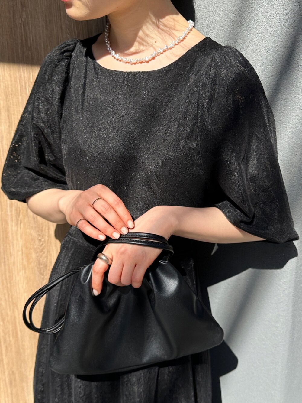 ブラック系のワンピース、ブラック系のショルダーバッグ、その他のその他を着用したレディースの春コーディネートの2枚目の写真