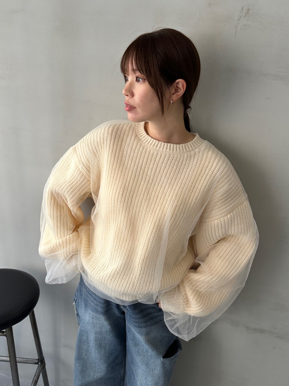 ホワイト系のニット/セーター、ブルー系のデニムパンツ、ベージュ系のスニーカーを着用したレディースの冬コーディネートの5枚目の写真