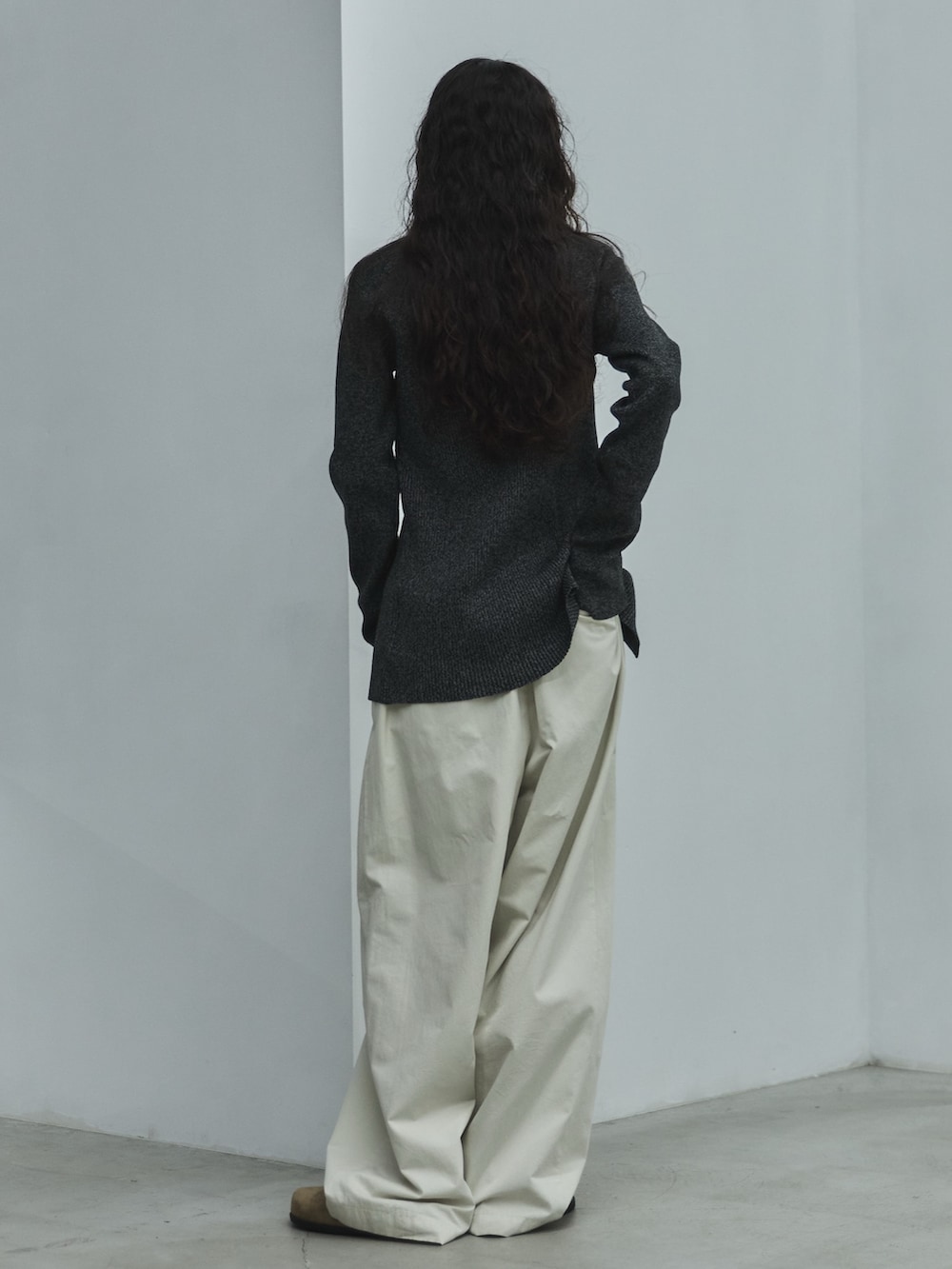 ブラック系のニット/セーター、ホワイト系のその他パンツ、ベージュ系のその他シューズを着用したレディースの秋コーディネートの3枚目の写真