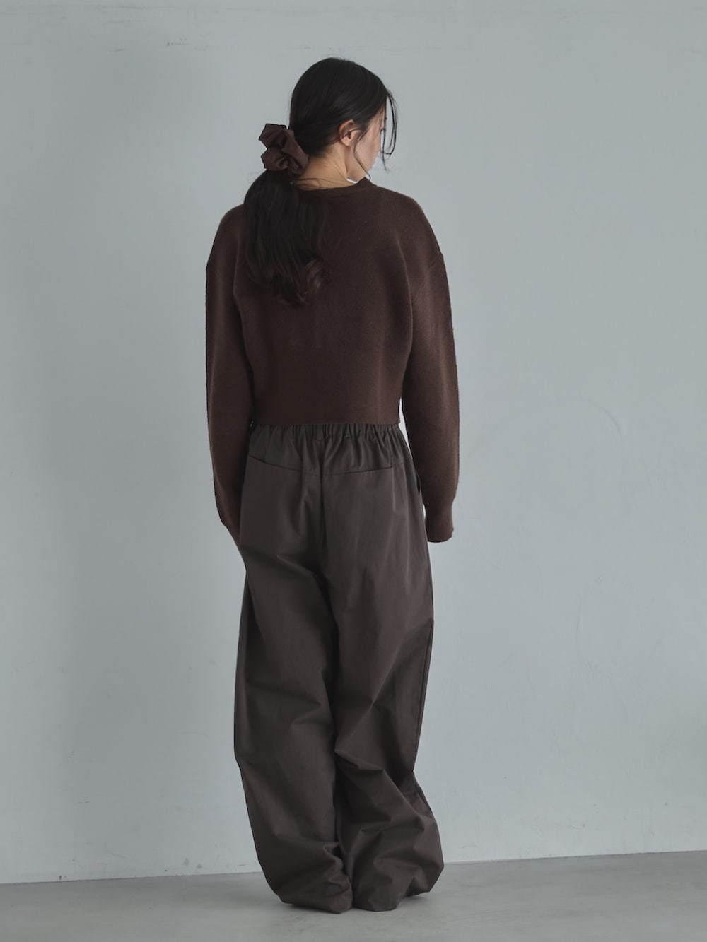 ブラウン系のカーディガン/ボレロ、ブラウン系のその他パンツ、ブラウン系のシュシュを着用したレディースの冬コーディネートの6枚目の写真