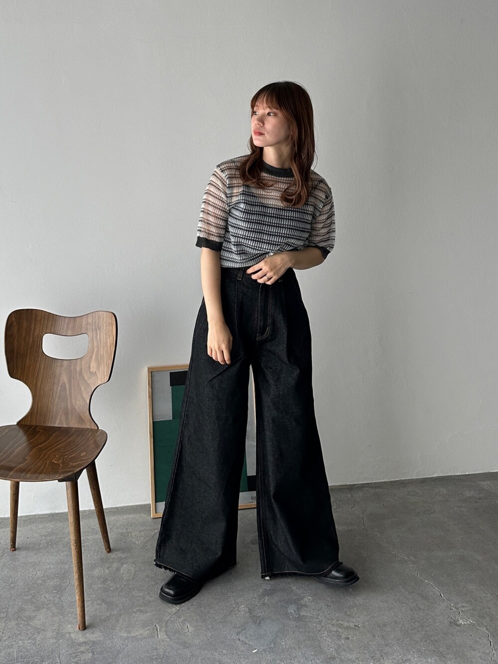 ブラック系のニット/セーター、ブラック系のデニムパンツ、ブラック系のスリッポンを着用したレディースの夏コーディネートの2枚目の写真