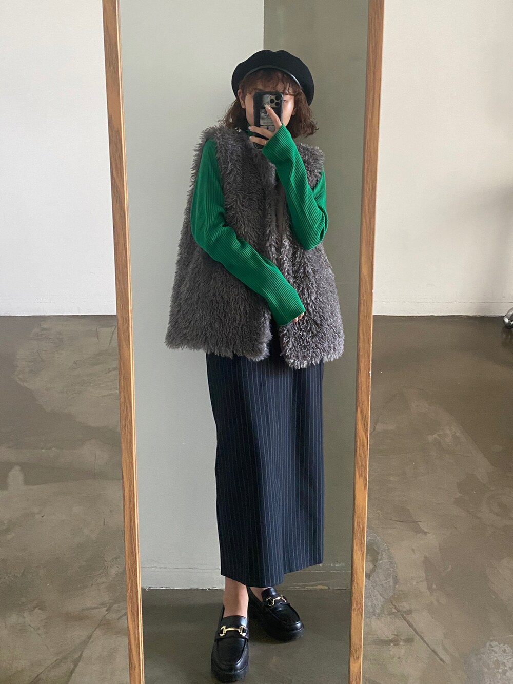 ホワイト系のスラックス、グレー系のベスト、ブルー系のニット/セーターを着用したレディースの秋コーディネートの3枚目の写真