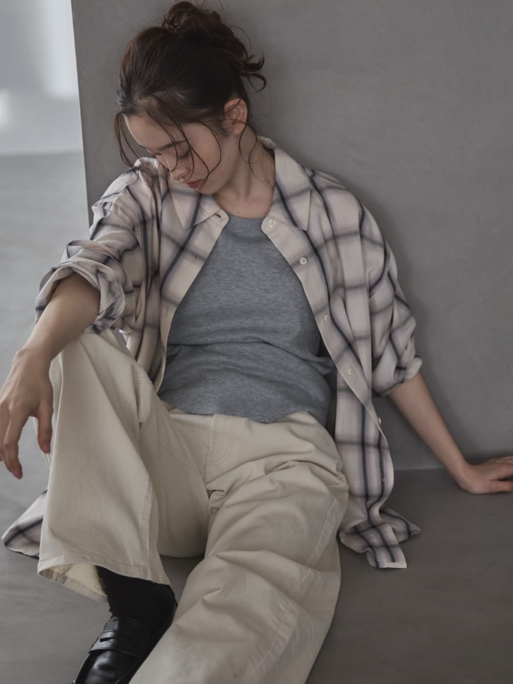 ホワイト系のシャツ/ブラウス、グレー系のタンクトップ、ホワイト系のデニムパンツを着用したレディースの冬コーディネートの6枚目の写真