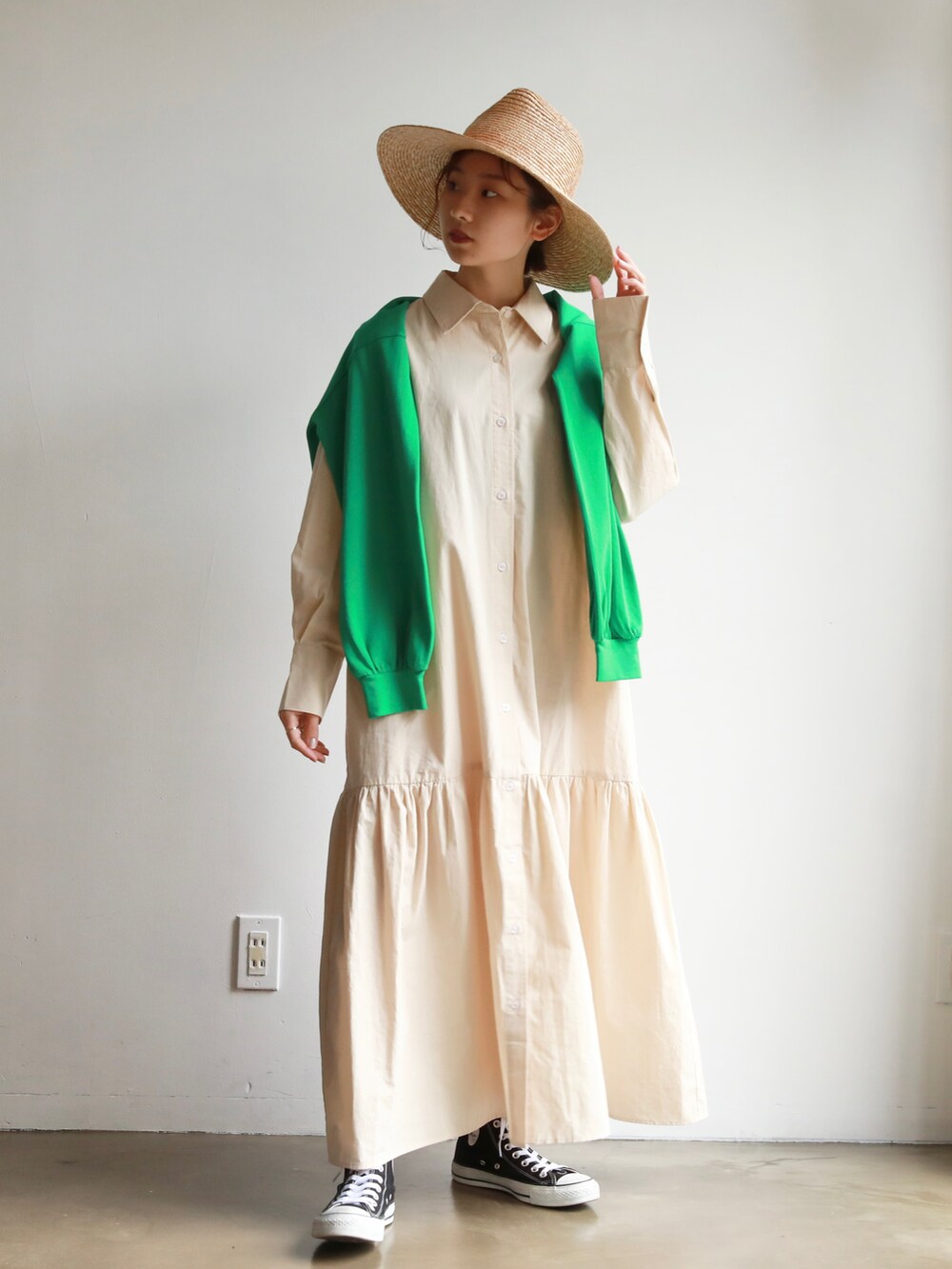 ブラック系のスニーカー、グリーン系のカーディガン/ボレロ、ベージュ系のシャツワンピースを着用したレディースの春コーディネートの2枚目の写真