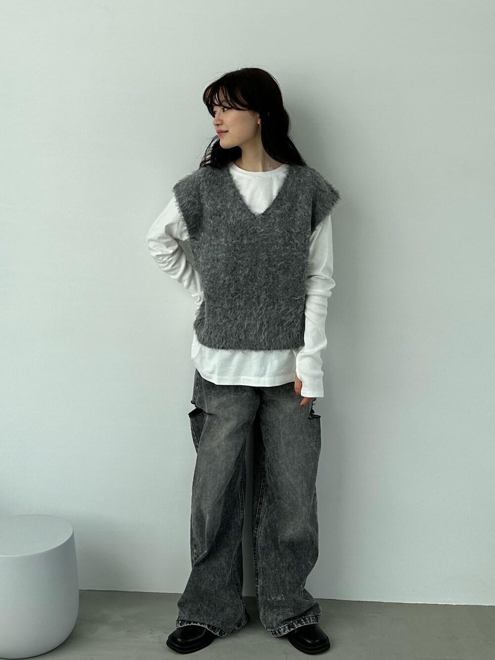 グレー系のベスト、ブラック系のデニムパンツ、その他のその他を着用したレディースの秋コーディネートの4枚目の写真