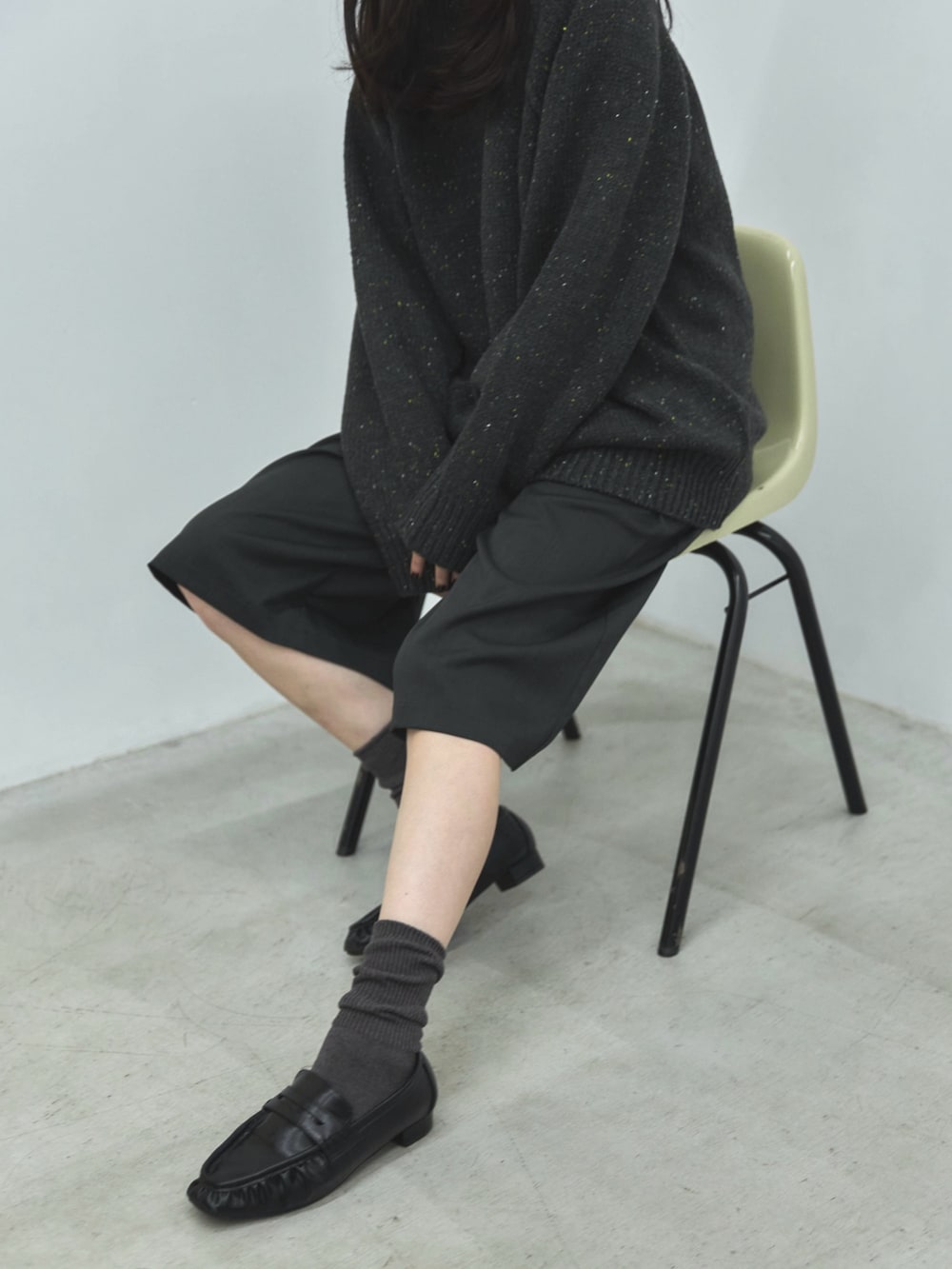 グレー系のニット/セーター、グレー系のその他パンツ、ブラック系のローファーを着用したレディースの秋コーディネートの5枚目の写真