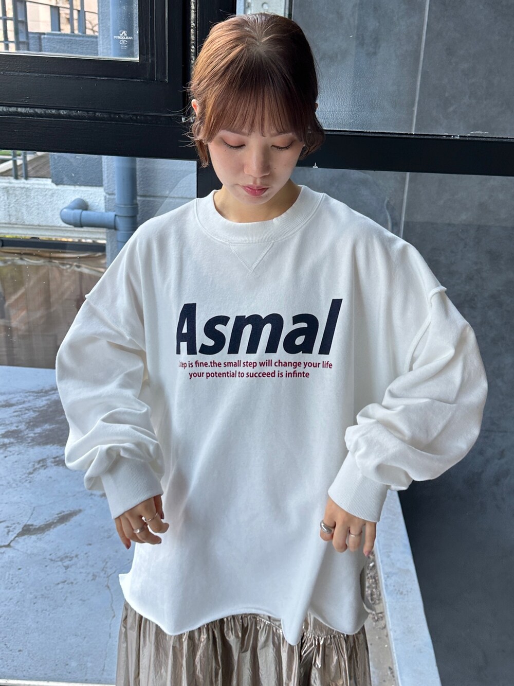 ブラック系のスニーカー、ホワイト系のスウェット、ゴールド系のスカートを着用したレディースの冬コーディネートの4枚目の写真