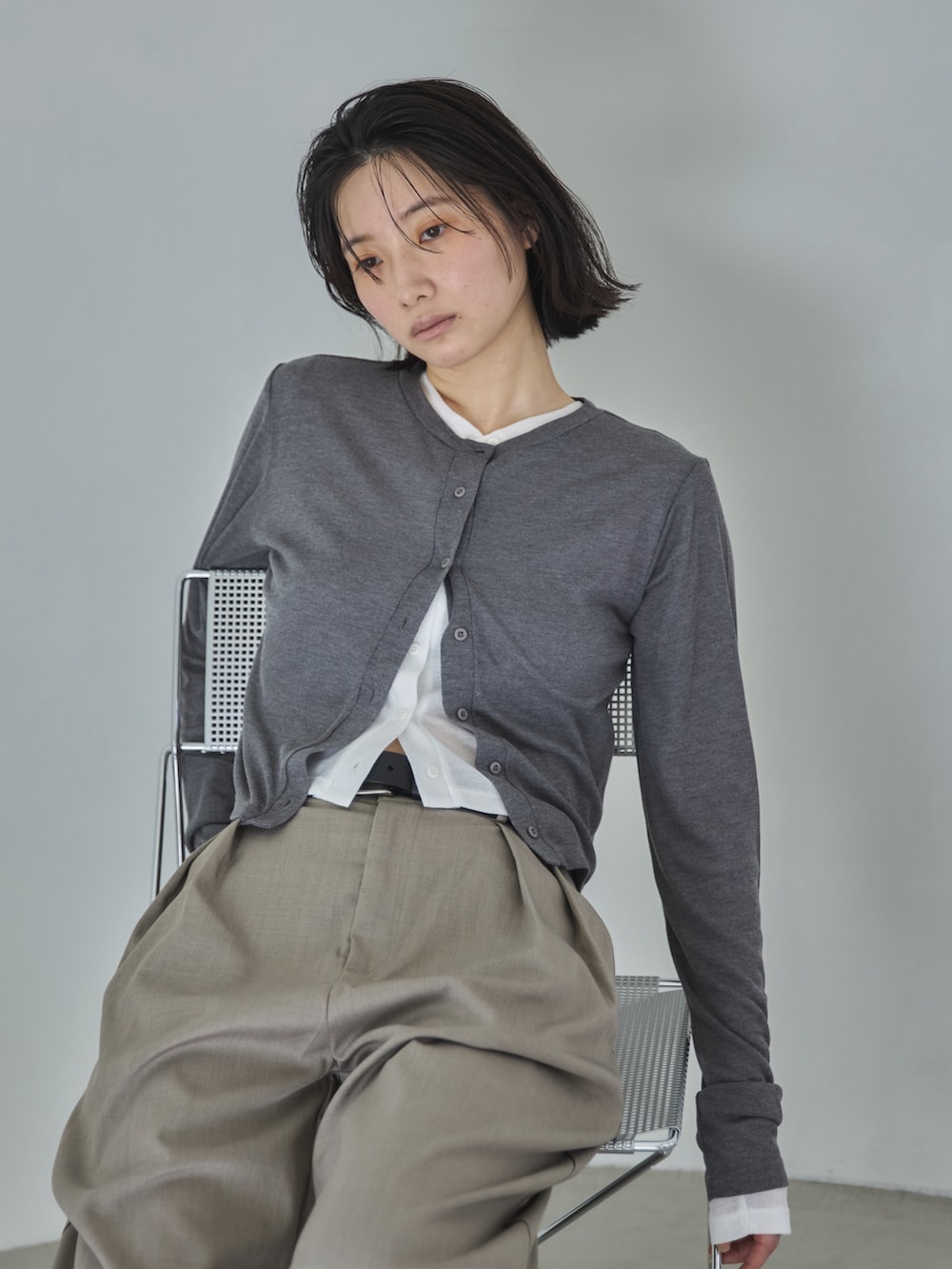 ベージュ系のスラックス、グレー系のカーディガン/ボレロ、ホワイト系のカーディガン/ボレロを着用したレディースの冬コーディネートの4枚目の写真