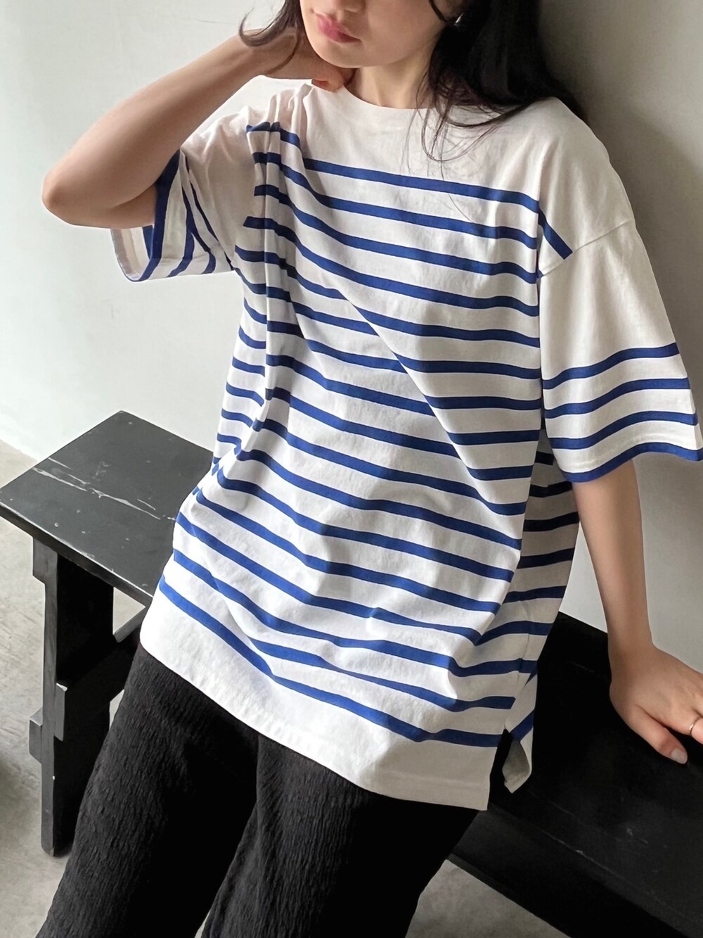 ホワイト系のTシャツ/カットソー、ブラック系のスラックス、ブラック系のサンダルを着用したレディースの春コーディネートの2枚目の写真