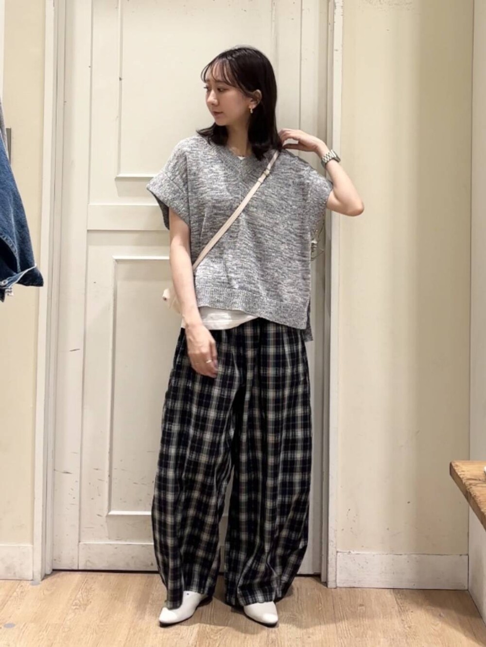 ベージュ系のショルダーバッグ、ホワイト系のパンプス、ホワイト系のタンクトップを着用したレディースの春コーディネートの3枚目の写真