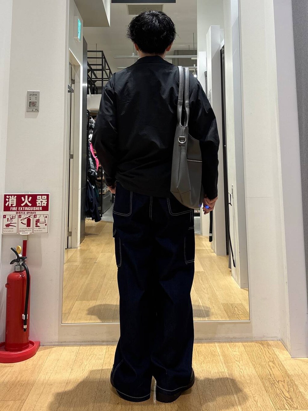 ブラック系のローファー、グレー系のトートバッグ、ホワイト系のTシャツ/カットソーを着用したメンズの春コーディネートの3枚目の写真