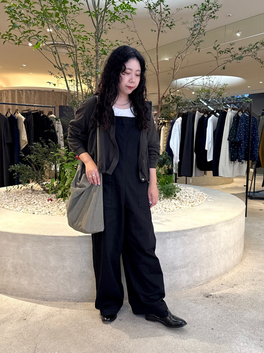 ブラック系のサロペット/オーバーオール、ブラック系のシャツ/ブラウス、グレー系のショルダーバッグを着用したレディースの夏コーディネートの4枚目の写真