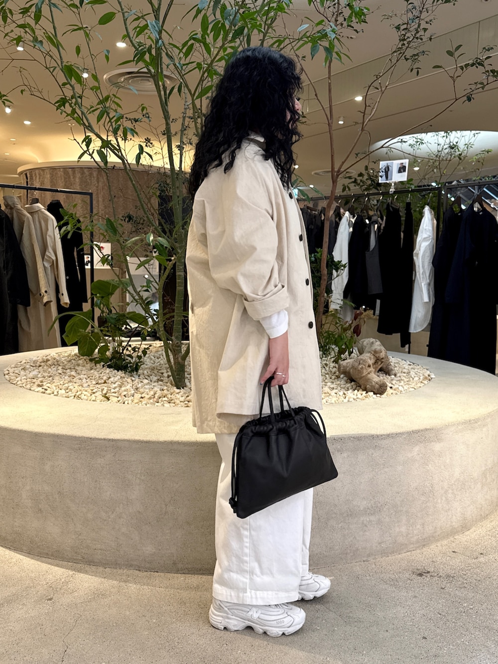 ブラック系のバッグ、ホワイト系のTシャツ/カットソー、ホワイト系のその他アウターを着用したレディースの冬コーディネートの3枚目の写真