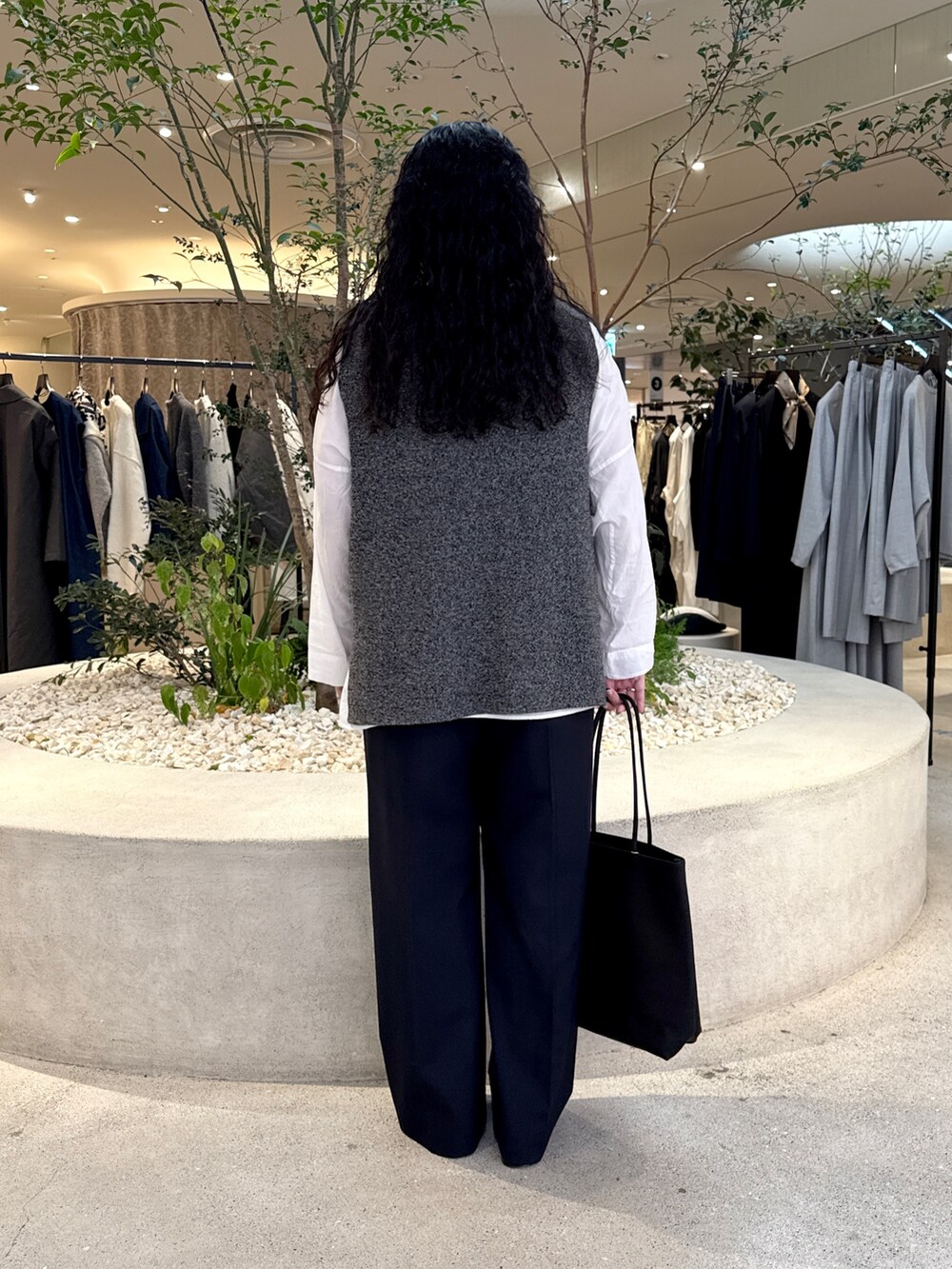 ホワイト系のシャツ/ブラウス、グレー系のニット/セーター、ブルー系のその他パンツを着用したレディースの秋コーディネートの4枚目の写真