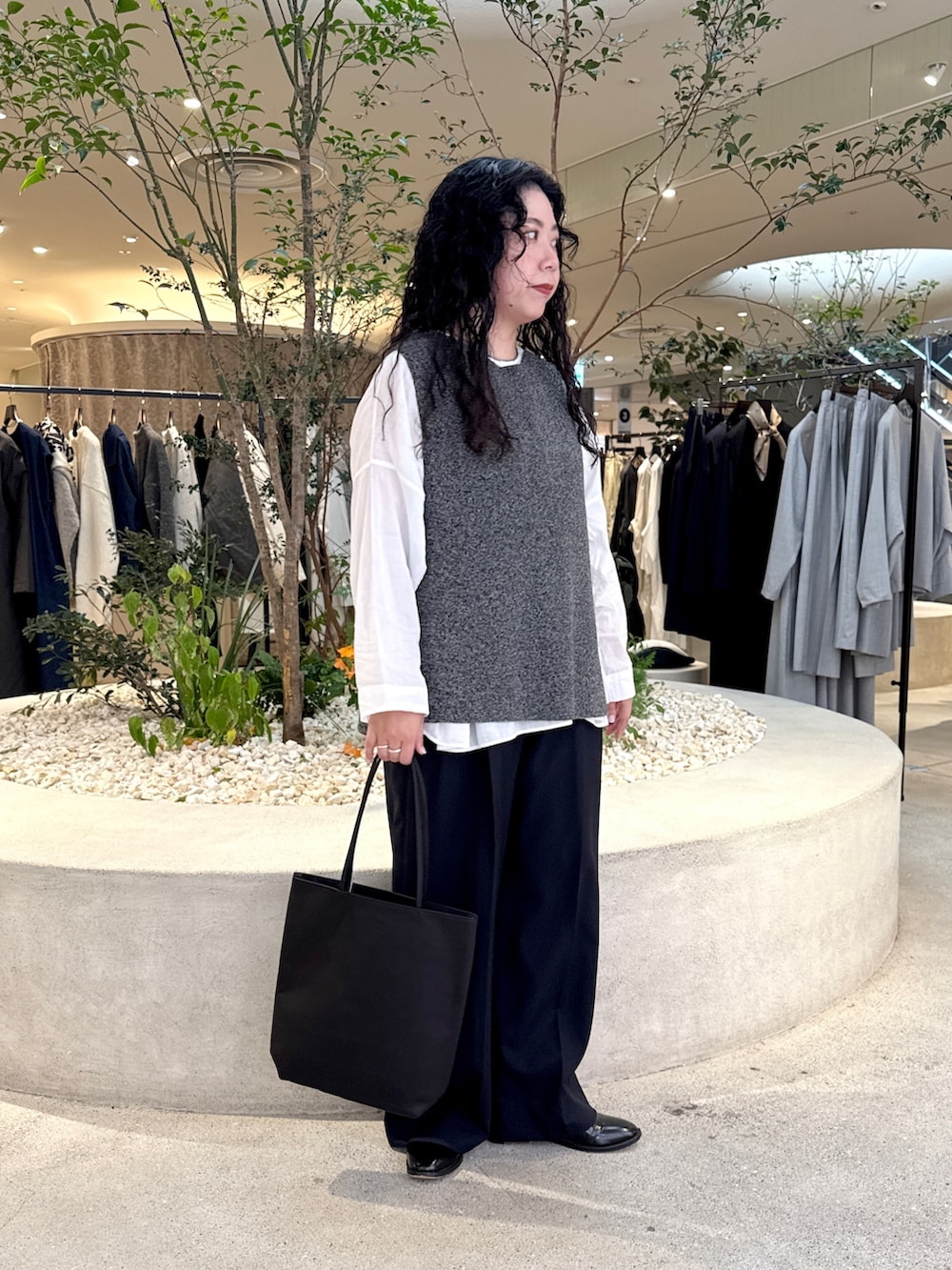 ホワイト系のシャツ/ブラウス、グレー系のニット/セーター、ブルー系のその他パンツを着用したレディースの秋コーディネートの2枚目の写真