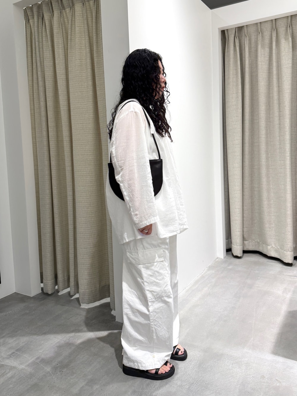 ホワイト系のシャツ/ブラウス、ホワイト系のその他パンツ、ブラック系のハンドバッグを着用したレディースの夏コーディネートの2枚目の写真