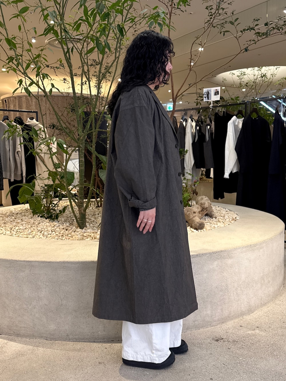 グレー系のニット/セーター、グレー系のその他アウター、ホワイト系のその他パンツを着用したレディースの冬コーディネートの2枚目の写真