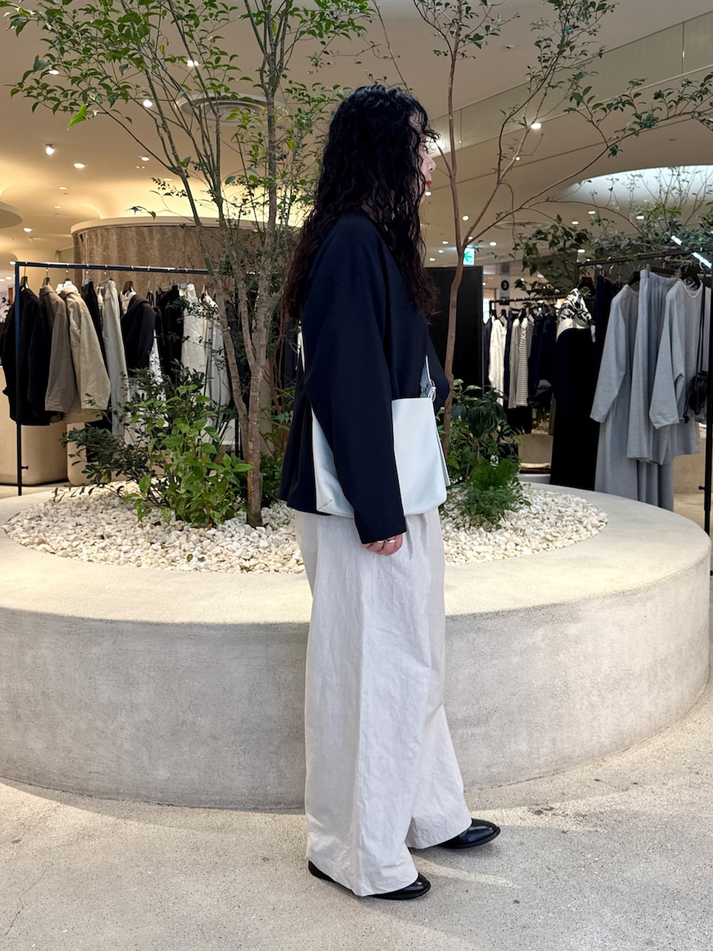 ホワイト系のショルダーバッグ、グレー系のその他パンツ、ブラック系のトップスを着用したレディースの秋コーディネートの2枚目の写真