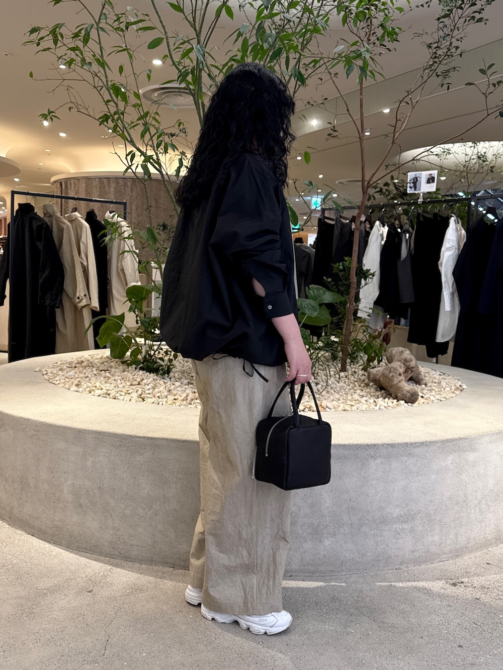 ブラック系のトートバッグ、ブラック系のシャツ/ブラウス、ベージュ系のその他パンツを着用したレディースの冬コーディネートの2枚目の写真