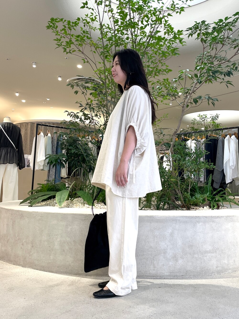 ベージュ系のデニムパンツ、ブラック系のバッグ、ベージュ系のシャツ/ブラウスを着用したレディースの秋コーディネートの2枚目の写真