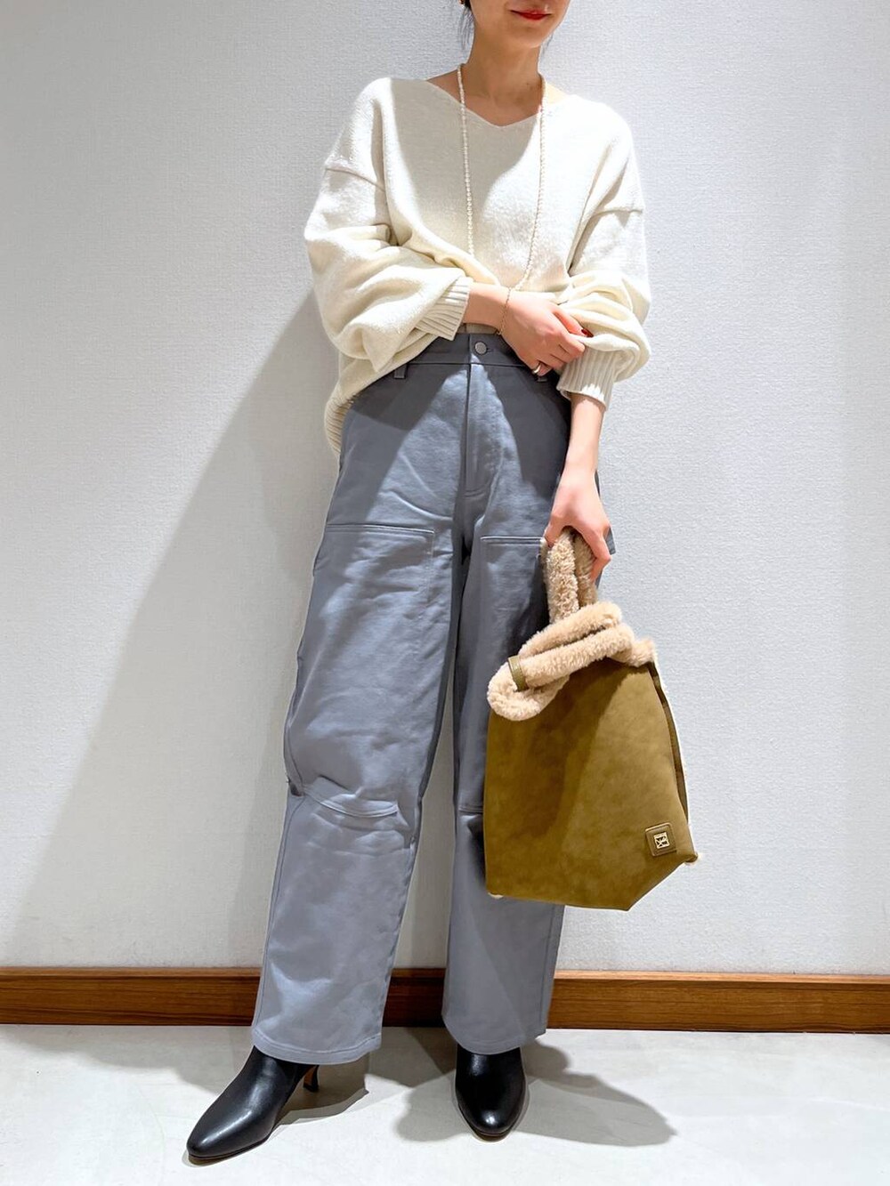 ブラック系のブーツ、グレー系のその他パンツ、ブラウン系のニット/セーターを着用したレディースの冬コーディネートの2枚目の写真