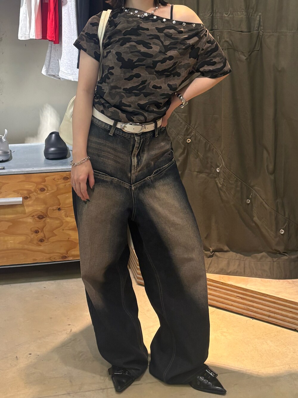 ブラック系のパンプス、ブルー系のデニムパンツ、グリーン系のTシャツ/カットソーを着用したレディースの夏コーディネートの2枚目の写真