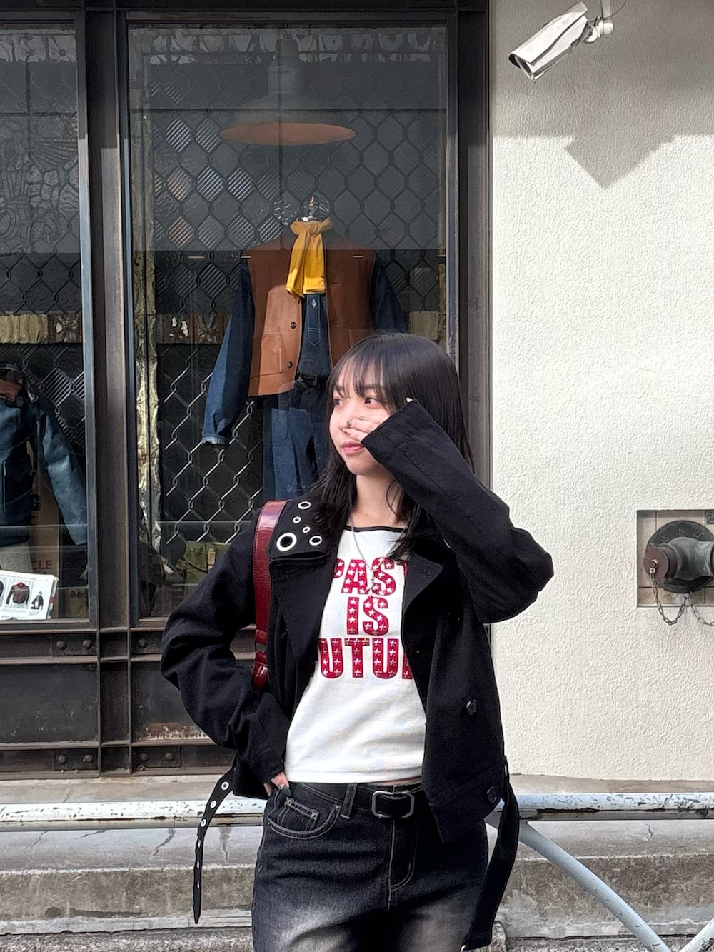 ブラック系のTシャツ/カットソー、ブラック系のピーコート、ブラック系のパンプスを着用したレディースの冬コーディネートの2枚目の写真