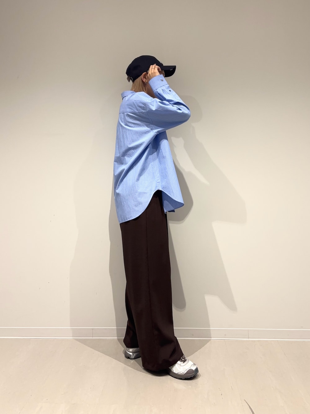 ブラウン系のその他パンツ、ブルー系のシャツ/ブラウス、グレー系のスニーカーを着用したレディースの春コーディネートの5枚目の写真