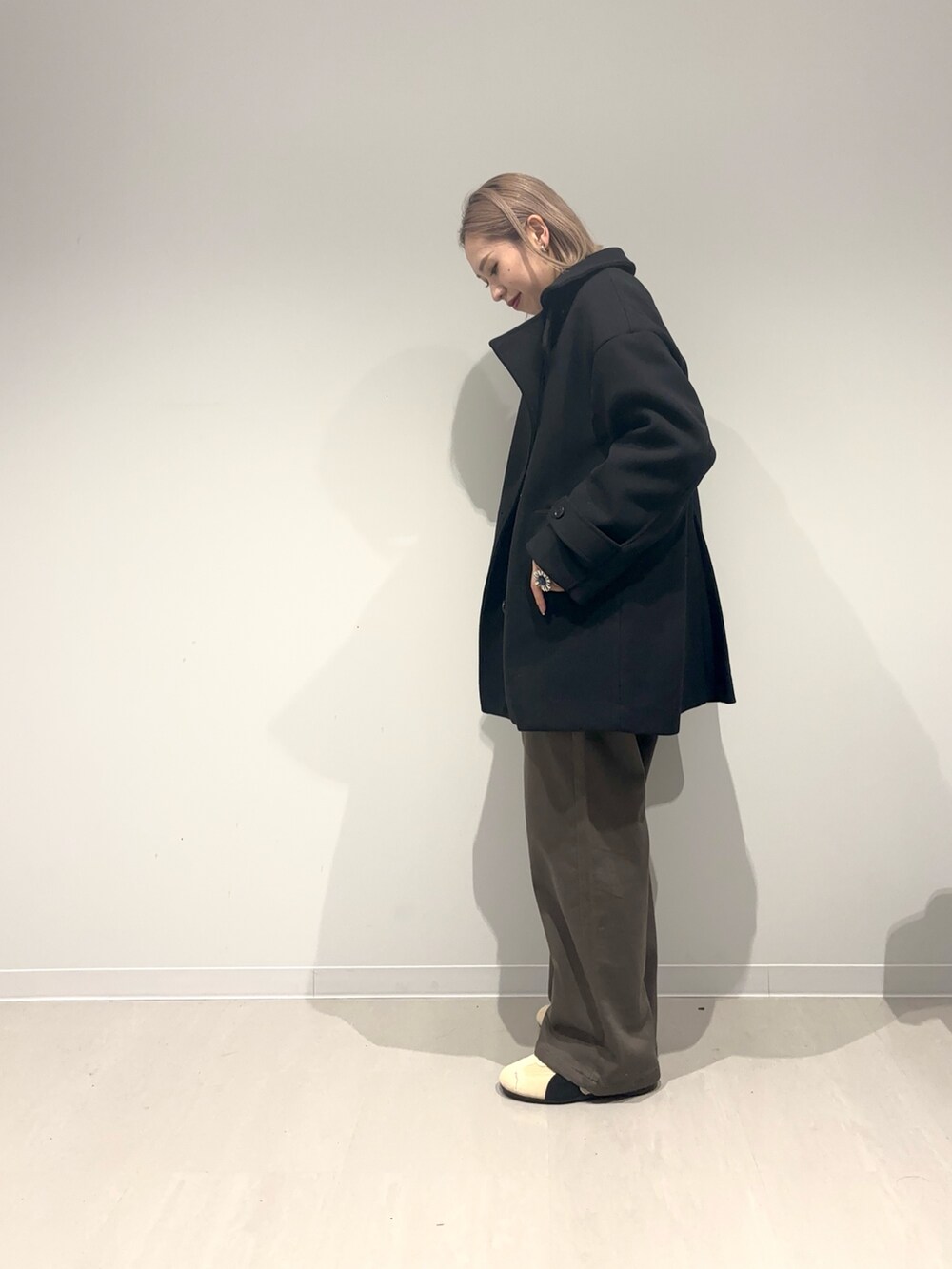 ブラック系のその他アウター、ベージュ系のスニーカー、グリーン系のその他パンツを着用したレディースの冬コーディネートの7枚目の写真