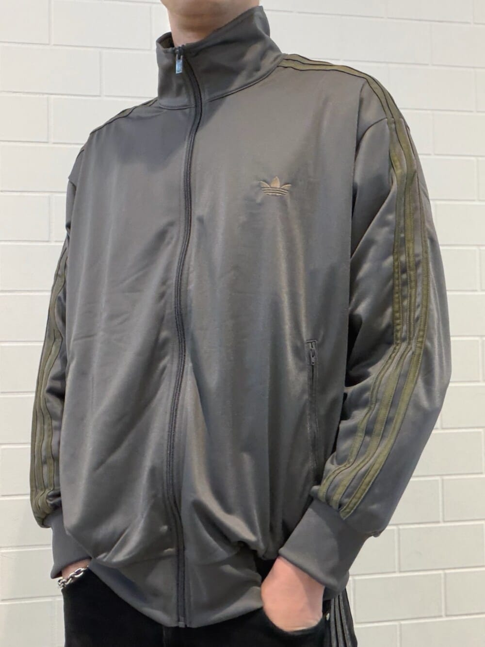 グレー系のトップス、ブラック系のスニーカーを着用したメンズの春コーディネートの3枚目の写真