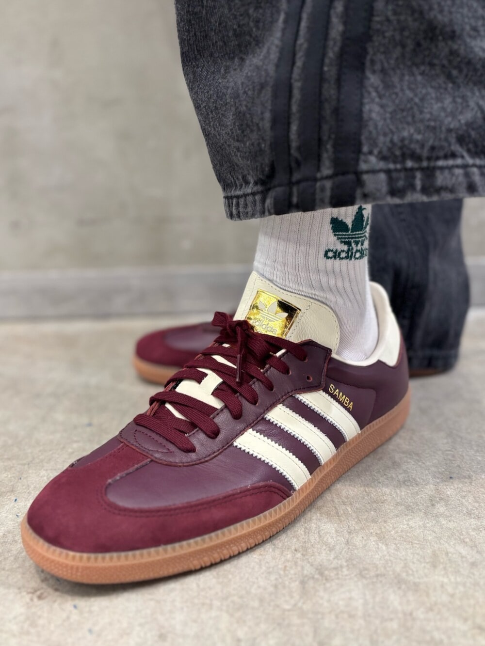 レッド系のスニーカー、ブラック系のデニムジャケット、ブラック系のデニムパンツを着用したメンズの冬コーディネートの8枚目の写真