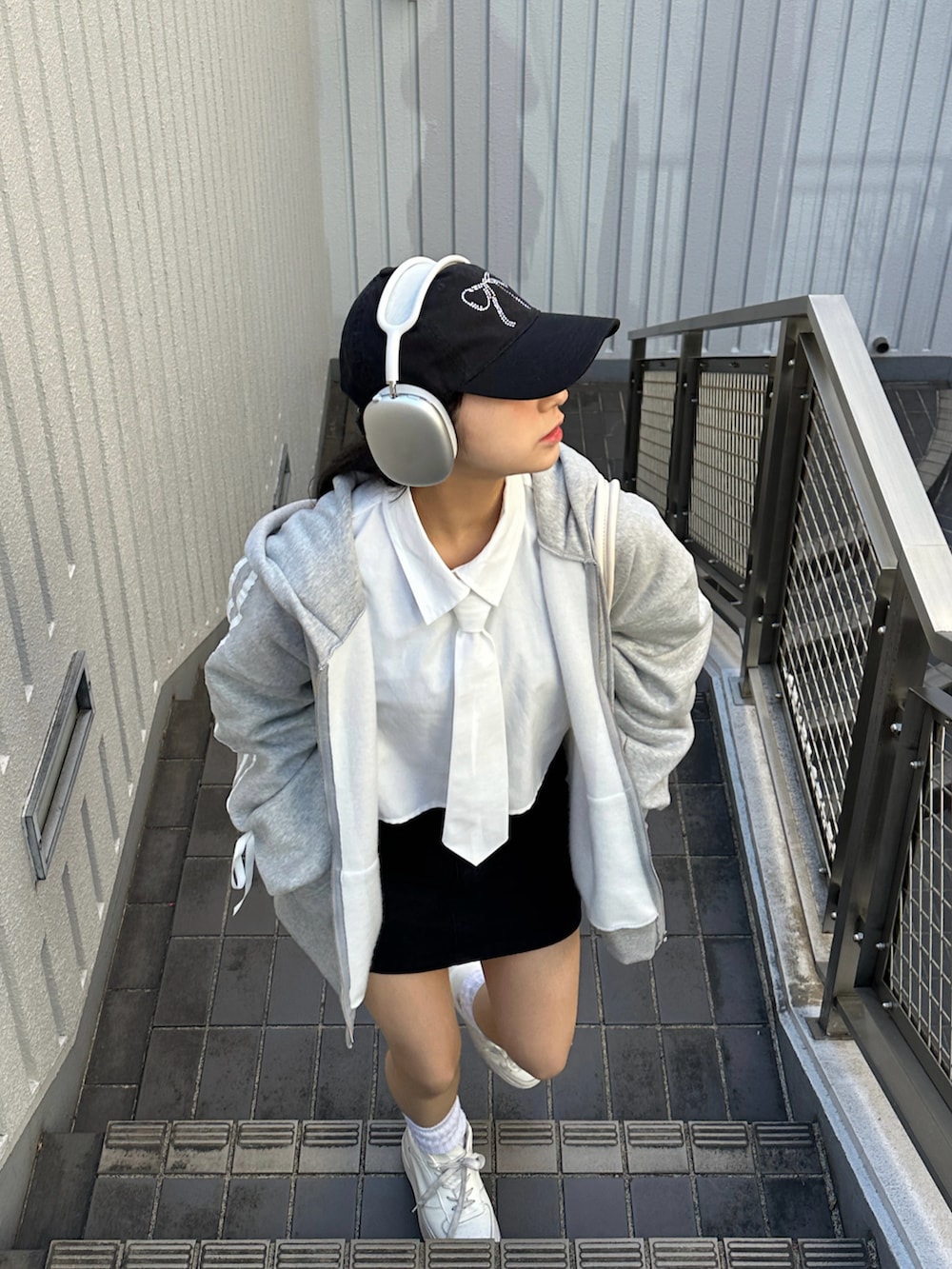 ブラック系のスカート、ホワイト系のシャツ/ブラウス、グレー系のジャケット/アウターを着用したレディースの冬コーディネートの2枚目の写真