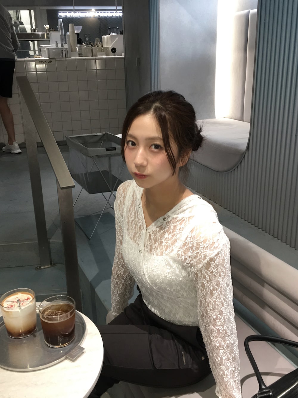 ブラック系のカーゴパンツ、ホワイト系のトップスを着用したレディースの夏コーディネートの2枚目の写真